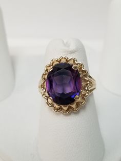 "Thanks for shopping our vintage estate store. We tend to sell well below wholesale and truly hope you enjoy all of our items. Many of the items are one of a kind, so please enjoy scrolling through the pictures and hopefully something will catch your eye. Brown spots are from camera or reflections. Estate 10k yellow gold purple blue 5ct sapphire cocktail filigree ring. Gem is testing natural, more than likely created, beautiful gem. Ring size: 5.5 Setting: 12mm 5/8\" Gem: 10mm by 12mm 5cts Band Estate Style Collectible Gemstone Jewelry, Estate Oval Jewelry For Gifts, Estate Style Round Jewelry Gift, Vintage 14k Stamped Amethyst Round Ring, Vintage 14k Stamped Amethyst Ring, Vintage Amethyst Ring With Accent Stones, Vintage Amethyst Ring With Accent Stones For Collectors, Vintage 14k Gold Amethyst Ring With Accent Stones, Estate Jewelry With Center Stone As Gift