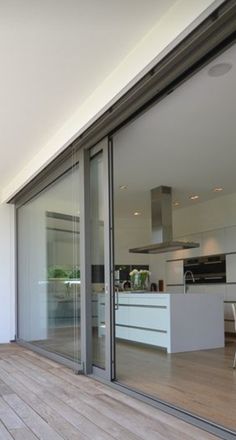 an outdoor patio with sliding glass doors and wooden flooring