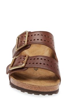 Perforations on the toe and brassy buckles give a stylish update to the classic Arizona sandal built with the same contoured footbed for comfort. Contoured footbed with arch support Leather upper and lining/synthetic sole Imported Classic Brown Slip-on Footbed Sandals, Classic Leather Footbed Sandals With Adjustable Fit, Classic Adjustable Leather Footbed Sandals, Classic Slide Sandals With Cushioned Footbed, Classic Slide Footbed Sandals With Cushioned Footbed, Classic Cushioned Slide Footbed Sandals, Classic Brown Footbed Sandals With Buckle Closure, Classic Leather Footbed Sandals With Arch Support, Classic Adjustable Slides With Leather Footbed