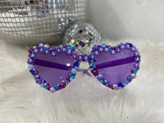 Be the life of the party on your big day with a pair of bedazzled birthday glasses! These glasses are the perfect gift for any birthday celebration and are a unique gift that's sure to shine. All of our glasses are custom made per order, allowing for changes in design, phrasing, and colors. Party proof glasses are the way to go, our glasses are guaranteed to stay intact and if for any reason you aren't satisfied with your purchase we offer a 100% money back guarantee.  *Custom made for each orde Fun Sunglasses As Valentine's Day Gift, Fun Sunglasses For Valentine's Day Gift, Fun Carnival Party Supplies As Gifts, Playful Party Sunglasses Personalized, Playful Party Sunglasses For Valentine's Day, Purple Party Sunglasses, Playful Sunglasses For Valentine's Day Party, Playful Personalized Sunglasses For Party, Personalized Playful Sunglasses For Party