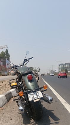 the motorcycle is parked on the side of the road