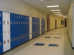 a hallway with rows of blue and white lockers