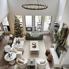 an aerial view of a living room with couches and christmas trees