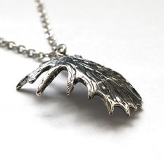 "This shed moose antler pendant is made of solid sterling silver. The recesses of the antler have been darkened to enhance the realistic veined texture of the palm. This stunning trophy antler pendant measures 1\" wide and 1-1/4\" long and is finished on all sides as shown so there is no \"wrong\" side. MOON RAVEN DESIGNS: Please check out the rest of our shop by clicking: http://www.etsy.com/shop/mrd74?ref=si_shop QUESTIONS: We are always happy to answer any of your questions, so please contact Antler Pendant, Moose Antlers, Wolf Ring, Button Studs, Antler Necklace, Silver Wolf, The Palm, Antlers, Random Things