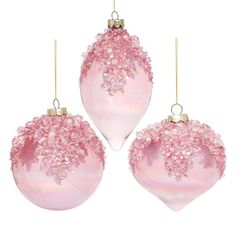 three pink ornaments hanging from strings on a white background