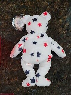 a white teddy bear with red and blue stars on it