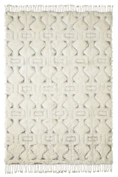 a white rug with fringes on it