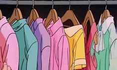 colorful shirts hanging on clothes racks in a closet