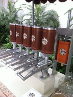 four beer kegs sitting on top of a counter next to a potted plant