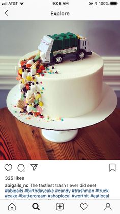 a white cake with a train on top and sprinkles all over it