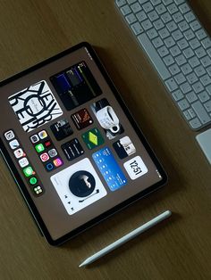 an ipad sitting on top of a wooden desk next to a keyboard