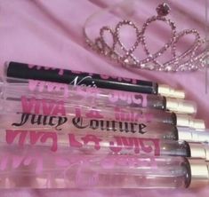 four lip glosses in plastic cases with a tiara on top