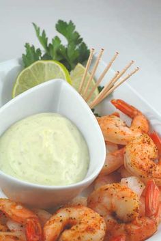 a plate topped with shrimp and dipping sauce