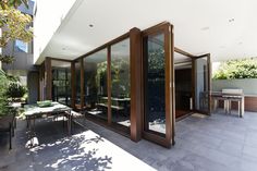 an outdoor dining area with sliding glass doors