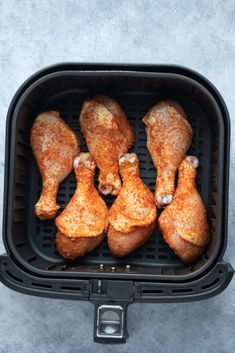 four chicken legs in an air fryer