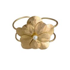 Elegance meets nature in this stunning piece, featuring a beautifully crafted flower design cuff, adorned with a beautiful pearl. Perfect for adding a touch of sophistication to any outfit, this cuff bracelet is a must-have for your jewelry accessory. Pair this cuff bracelet with the matching Flor Earrings and Flor Ring for a look that's effortlessly chic and undeniably elegant. gold filled non-tarnish pearl adjustable Flower Cuff Bracelet, Pearl Collection, Dainty Necklace, Bridal Collection, Pearl Bracelet, Flower Design, Cuff Bracelet, Flower Designs, Gold Filled