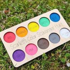 a box of colorful eyeshades sitting in the grass with some writing on it