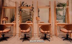 salon chairs and mirrors in front of a mirror with plants on it's sides