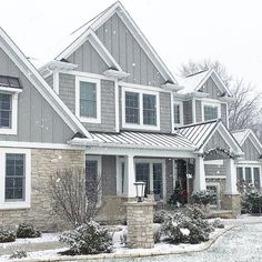 a row of houses with snow on the ground