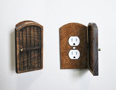 two wooden electrical outlets attached to a wall