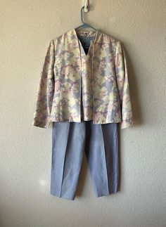 PAPELL 100% silk blazer and vest. Multi color floral patterns - lavender, beige, and light pink size 12  GRAFF petite pants size 10. 100% polyester. Pants and blazer colors are matching Measurements:  Vest - shoulder 14 1/2   bust 20   length 21   3 1/2 inch cut on side sides                               Blazer - shoulder 16   bust 22   sleeve 22   length 23                               Pants - waist 27 elastic band expands up to 39   rise 13   inseam 25   out seam 36   2 side pockets  Hem lin Spring Silk Sets With Floral Print, Spring Formal Suit With Floral Print, Spring Floral Print Formal Suits, Formal Floral Print Suits For Spring, Silk Sets For Spring Daywear, Spring Silk Workwear Set, Floral Print Sets For Spring Daywear, Fitted Purple Spring Sets, Spring Purple Fitted Sets