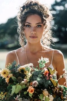 a woman holding a bouquet of flowers in her hands