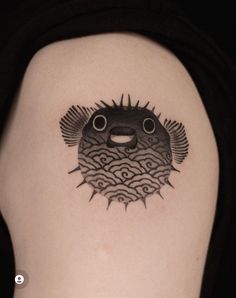 a black and white image of a fish on the back of a woman's shoulder