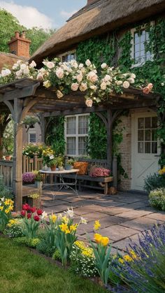 a garden with lots of flowers in front of a house