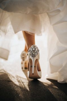 the bride's shoes are adorned with jewels