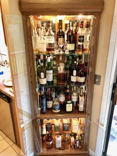 an open refrigerator filled with lots of liquor bottles