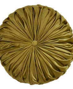 an olive green round pillow with pleaed fabric on the top and bottom, sitting in front of a white background