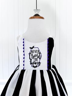 a black and white striped dress with the words never trust the wrong on it