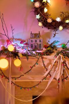 a decorated mantle with christmas lights and decorations