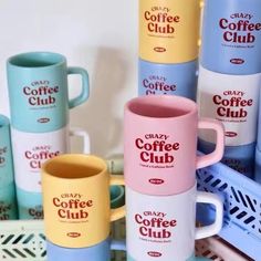 several coffee mugs stacked on top of each other in different colors and sizes,