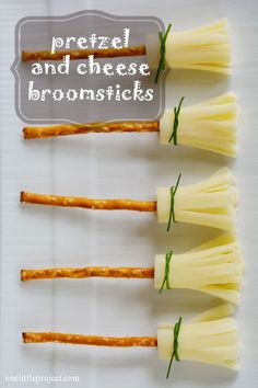 four pieces of cheese are arranged in the shape of toothpicks