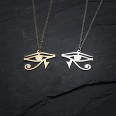 "This beautiful Egyptian Eye of Horus pendant is influenced by the ancient Egyptian culture that considered it as symbol of protection, Comes on a matching gold filled or sterling silver chain and arrives in our signature gift box, ready for gift giving to the lovers in your life. ★ Comes in our signature gift box, ready for gift giving. ★ Available in Silver [Sterling silver chain & silver plated pendant] ★ Available in Gold [18k Gold filled chain & 18k gold plated brass pendant] ★ Pend Gold Evil Eye Symbolic Necklace, Gold Plated Evil Eye Symbolic Jewelry, Symbolic Gold Plated Evil Eye Jewelry, Spiritual Gold Eye-shaped Necklace, Brass Evil Eye Jewelry As A Gift, Evil Eye Brass Jewelry As A Gift, Brass Evil Eye Jewelry For Gifts, Gold Symbolic Evil Eye Charm Necklaces, Symbolic Gold Evil Eye Charm Necklaces