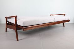 a wooden bench with a white cushion on it