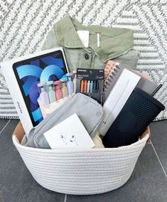 a basket filled with items sitting on top of a tiled floor