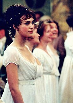 several women in white dresses standing next to each other