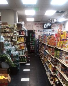 an aisle in a grocery store filled with lots of food and drinks on the shelves