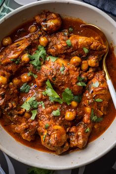 a white bowl filled with meat and garnish