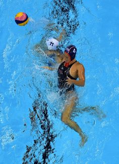 two people are playing water polo in the pool