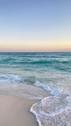 the ocean waves are rolling in to shore