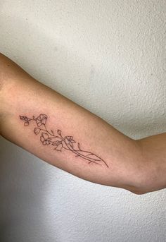 a woman's arm with a flower tattoo on it