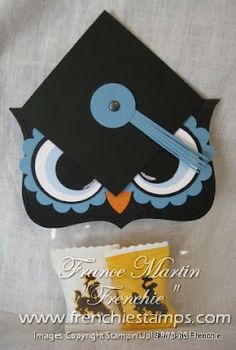 a black and blue graduation cap with an owl on it