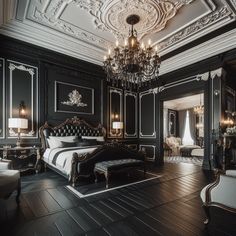 an ornate bedroom with black walls and wood floors