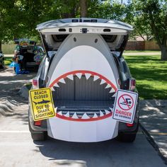 a car that has been decorated to look like a shark with it's mouth open