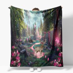 a woman is standing in front of a blanket with an image of a deer on it