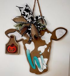 a cow head hanging on the wall with a tag attached to it's ear