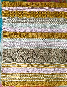 a knitted blanket with different colors and patterns